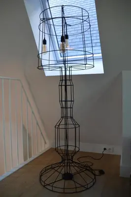 a bird cage in a room with a ceiling at Antwerp old town triplex apartment in Antwerp