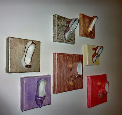 a wall with different types of shoes and boxes at Antwerp old town triplex apartment in Antwerp