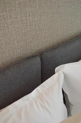 a close up of a bed with a pillow at Hotel De Zalm in Herentals