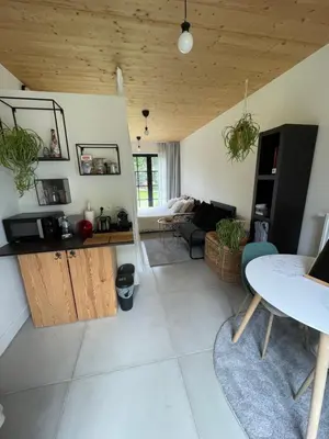 a living room with a table and a couch at de graslelie in Schoten