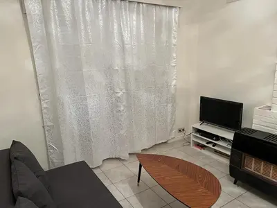 a living room with a couch and a television at Appartements Brussel in Brussels