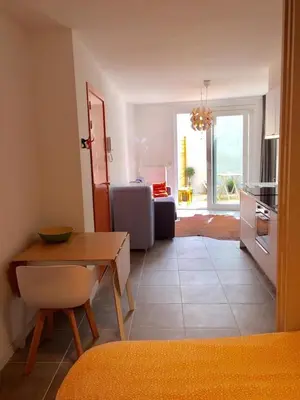 a kitchen and living room with a table and a dining room at Studio Liepoo in Ghent