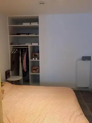a bedroom with a bed and a closet at Studio Liepoo in Ghent