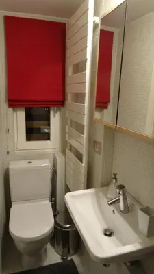 a bathroom with a white toilet and a sink at Maison Montana in Brussels