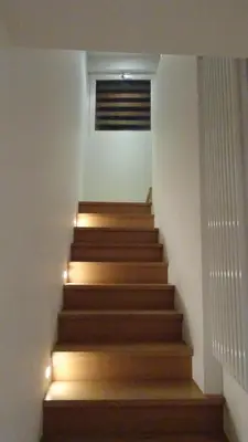 a stairway with wooden steps with led lighting at Maison Montana in Brussels