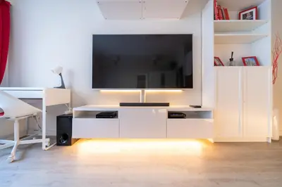 a white entertainment center with a flat screen tv at Luxury Studio In the EU Area in Brussels