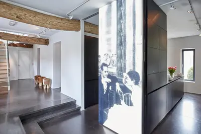 a hallway with a wall with a picture of two men at B&B Park7 in Huldenberg