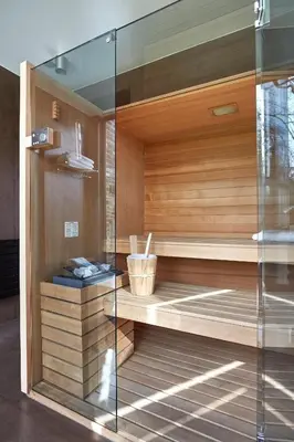 a sauna in a room with a glass wall at B&B Park7 in Huldenberg