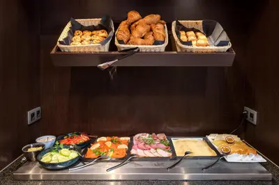 a bunch of different types of food on a shelf at Martin's Patershof in Mechelen