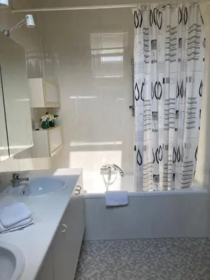a bathroom with a sink and a shower curtain at RS10 B&B Turnhout in Turnhout