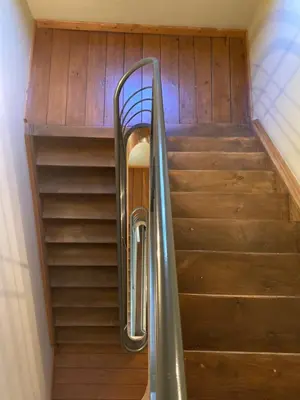 a spiral staircase with a metal handrail in a building at RS10 B&B Turnhout in Turnhout