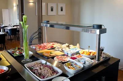 a buffet with many different types of food on a table at Hotel Karmel in Herentals
