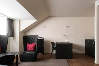 a room with a desk and a chair and a table at Hotel Karmel in Herentals