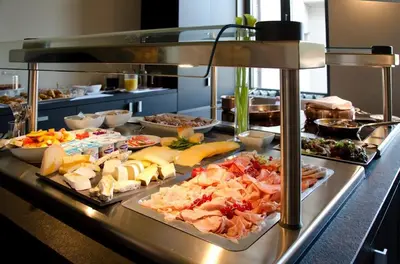 a buffet line with many different types of food at Hotel Karmel in Herentals