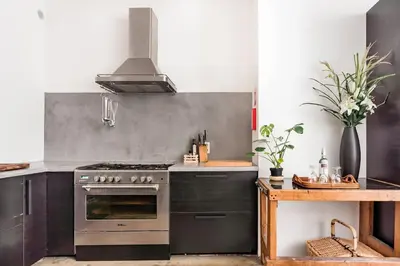 a kitchen with a stainless steel stove and a counter at PAKHUIS in Ghent