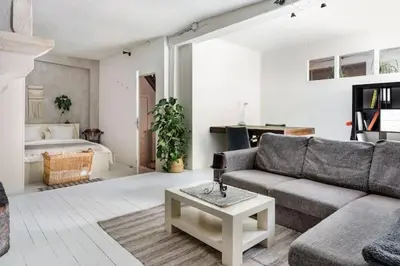 a living room with a couch and a table at PAKHUIS in Ghent