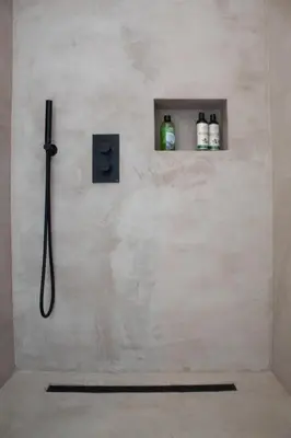 a shower in a bathroom with two bottles on a wall at PAKHUIS in Ghent