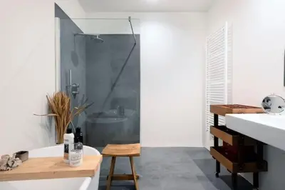 a bathroom with a shower and a tub and a sink at PAKHUIS in Ghent