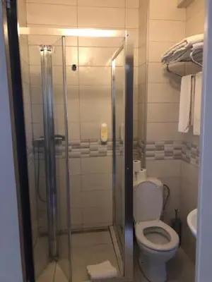 a bathroom with a toilet and a glass shower at Prestige Flats Coteaux in Brussels