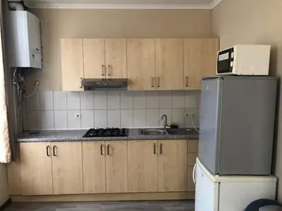 a kitchen with a refrigerator and a sink at Prestige Flats Coteaux in Brussels