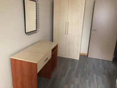 a room with a wooden counter and a mirror at Prestige Flats Coteaux in Brussels