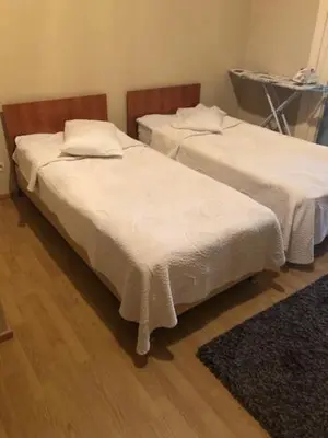 two beds with white sheets in a room at Prestige Flats Coteaux in Brussels