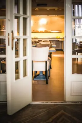 a door leading into a restaurant with a table and chairs at Antwerp Harbour Hotel in Antwerp