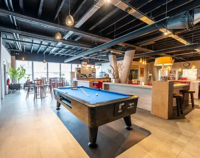 a pool table in a room with a bar at Antwerp Harbour Hotel in Antwerp