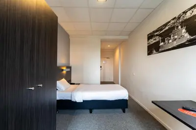 a hotel room with a bed and a desk at Antwerp Harbour Hotel in Antwerp