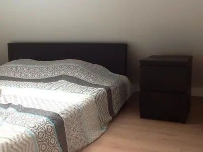 a bedroom with a bed and a night stand at Akker duplex in Mortsel