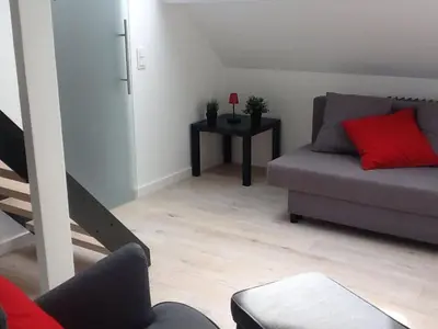 a living room with a couch and a table at Akker duplex in Mortsel