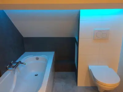 a bathroom with a tub and a toilet and a sink at Akker duplex in Mortsel