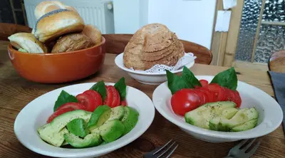 a table with plates of food and bowls of bread at Henriëtta in Hoboken
