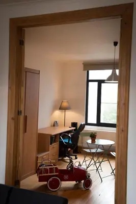a room with a desk and a red toy car in it at Henriëtta in Hoboken