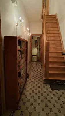 a hallway with a staircase and a tiled floor at Henriëtta in Hoboken