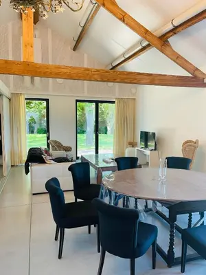 a living room with a table and chairs at Landlord bij Leuven in Holsbeek