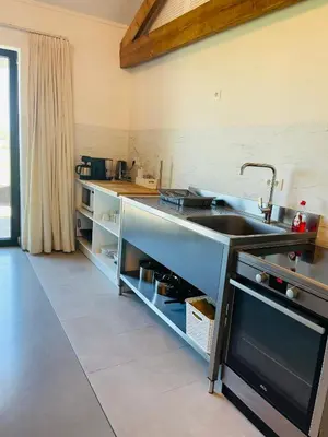 a kitchen with a sink and a counter at Landlord bij Leuven in Holsbeek
