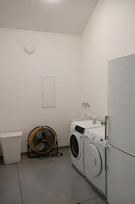 a laundry room with a washing machine and a refrigerator at Landlord bij Leuven in Holsbeek