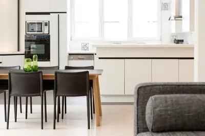 a kitchen with a table and chairs and a couch at Hotel Ter Elst in Edegem