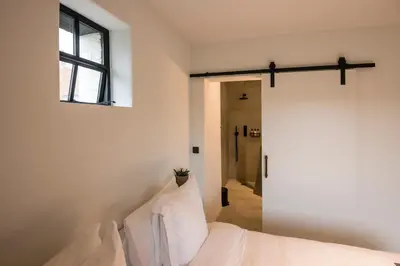a bedroom with a bed and a window at B&B Amelhof in Meise