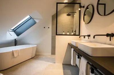 a bathroom with two sinks and a bath tub at B&B Amelhof in Meise