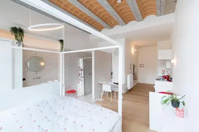 a bedroom with a white bed and a desk at The Hide in Ghent