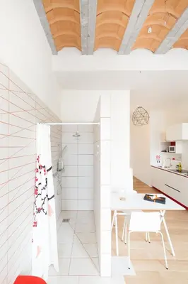 a white bathroom with a shower and a table at The Hide in Ghent