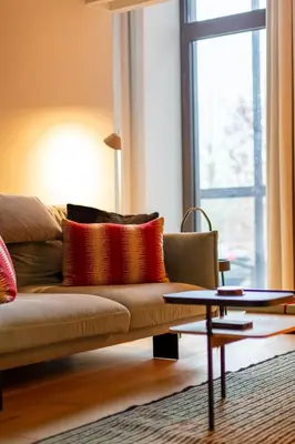 a living room with a couch and a table at The Hide in Ghent