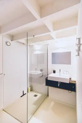 a bathroom with a glass shower and a sink at The Hide in Ghent
