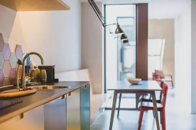 a kitchen with a sink and a table at The Hide in Ghent