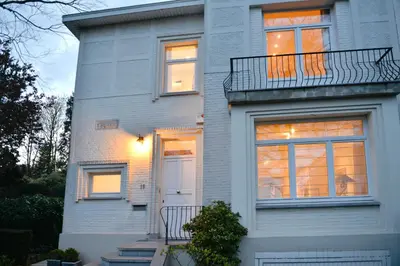 a white house with a white door and windows at B&B Salve in Brussels