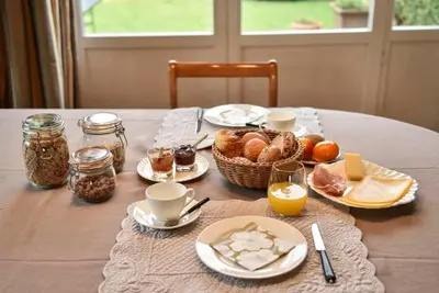 a table with a breakfast of bread and eggs and coffee at B&B Salve in Brussels
