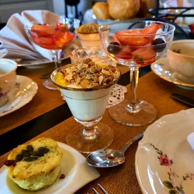 a table topped with a dessert and glasses of wine at B&B La Corderie in Hamme
