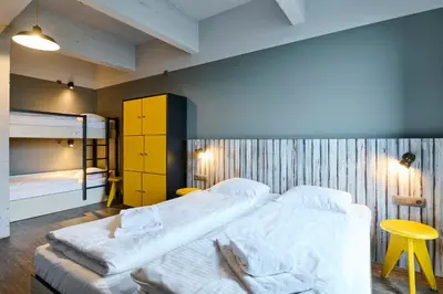 a bedroom with two beds and a bunk bed at MEININGER Hotels Bruxelles City Center in Brussels
